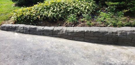 Decorative concrete retaining wall designed to look like natural stone